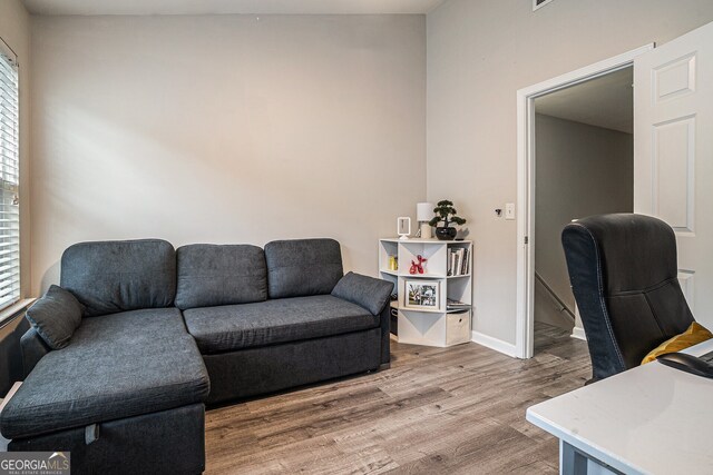 home office with a wealth of natural light, wood finished floors, and baseboards