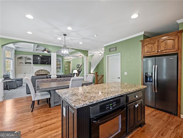 kitchen featuring crown molding, oven, light wood-type flooring, arched walkways, and stainless steel fridge with ice dispenser