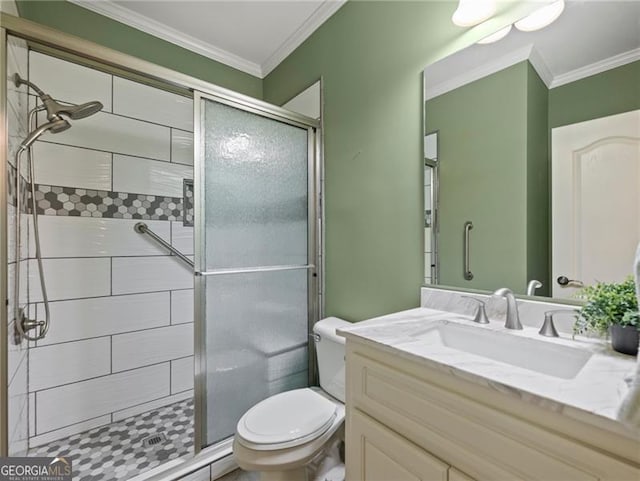 full bathroom featuring toilet, vanity, ornamental molding, and a stall shower
