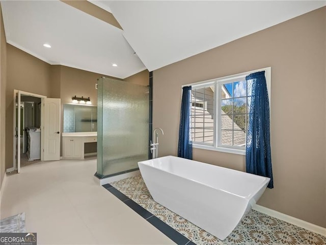 bathroom with recessed lighting, a freestanding bath, vanity, a walk in shower, and baseboards