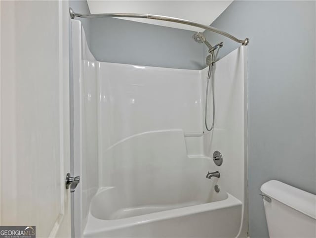 bathroom with toilet and washtub / shower combination