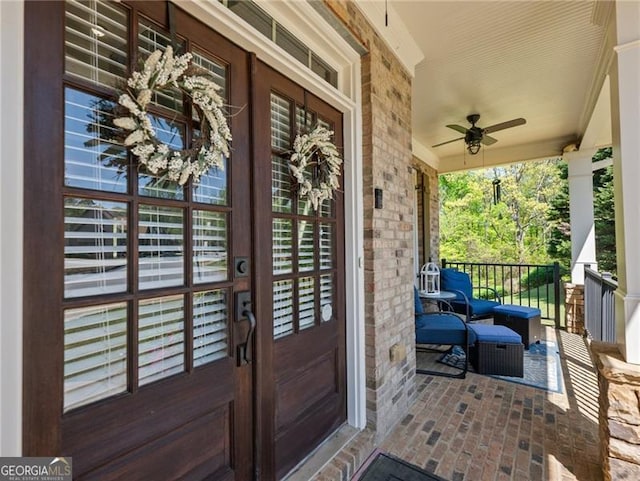 property entrance with a ceiling fan, french doors, and covered porch