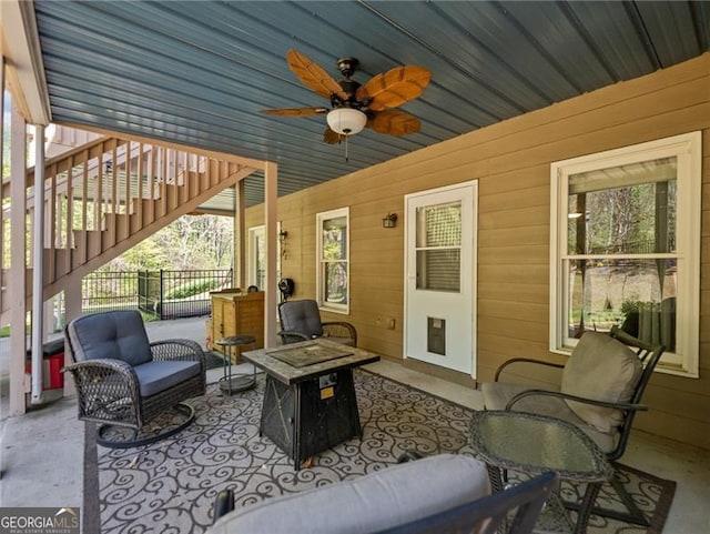 view of patio / terrace featuring fence, an outdoor living space, and a ceiling fan