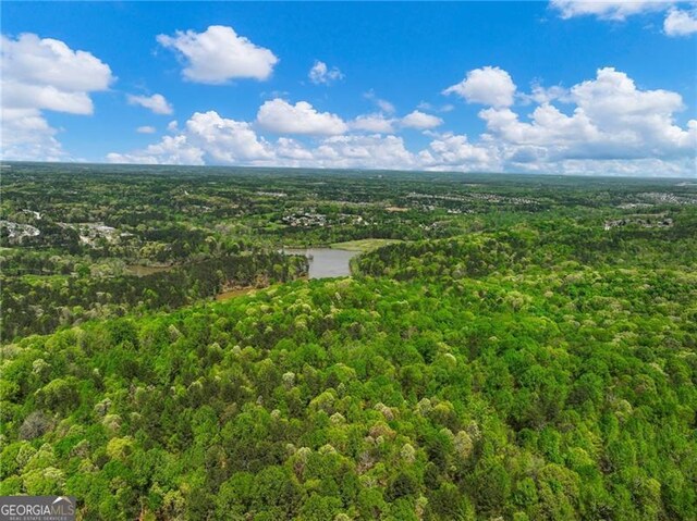 drone / aerial view with a wooded view