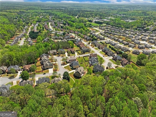 birds eye view of property featuring a residential view and a forest view
