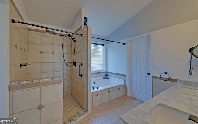 2800 Araglin Dr, Dacula, GA 30019 - bathroom featuring a bath, a sink, double vanity, tiled shower, and lofted ceiling