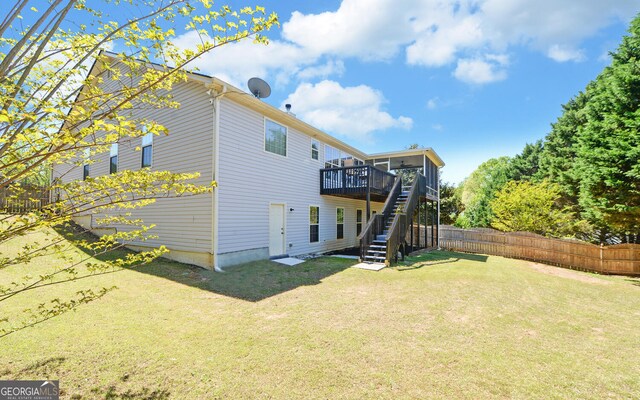 2800 Araglin Dr, Dacula, GA 30019 - back of property with stairway, a wooden deck, a lawn, and fence