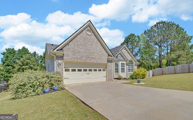 2800 Araglin Dr, Dacula, GA 30019 - view of front of home with a front lawn, driveway, an attached garage, fence, and brick siding