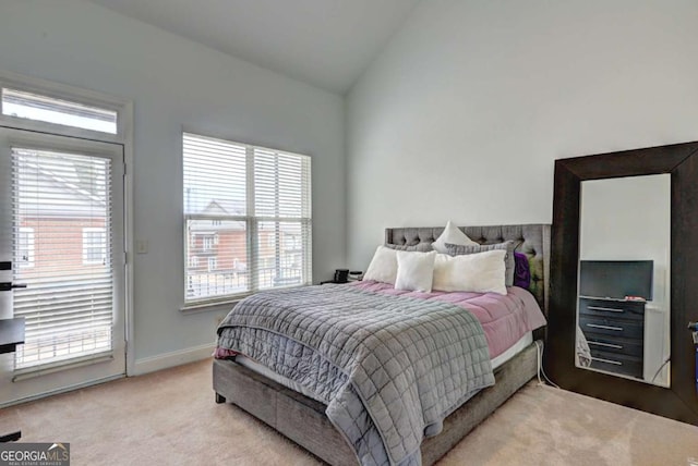bedroom featuring vaulted ceiling, carpet flooring, access to outside, and multiple windows