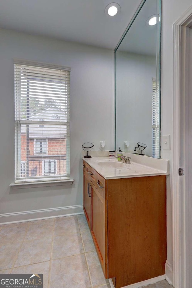 bathroom with recessed lighting, baseboards, tile patterned flooring, and vanity