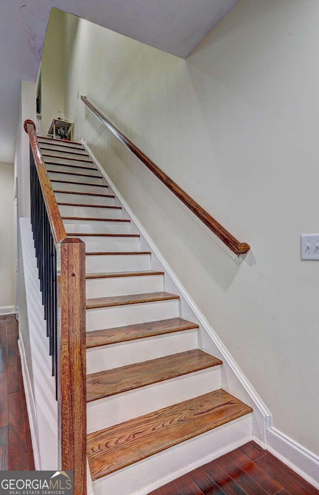 stairs with baseboards and hardwood / wood-style flooring