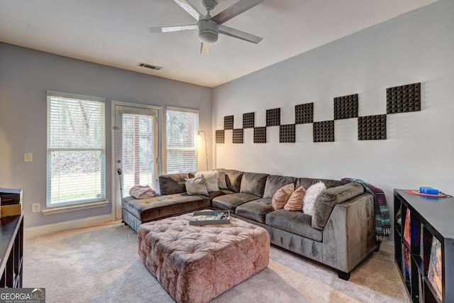 living area with ceiling fan, baseboards, carpet flooring, and visible vents