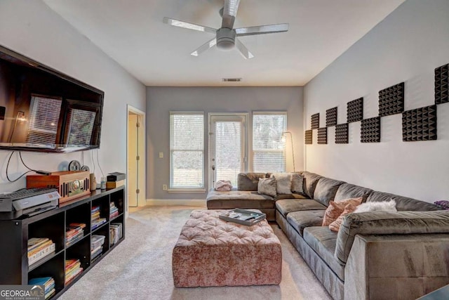 carpeted living area with baseboards, visible vents, and ceiling fan