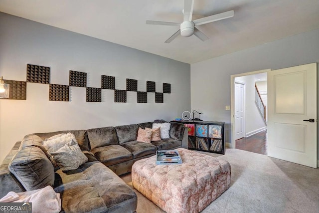 living area with baseboards, a ceiling fan, and carpet flooring