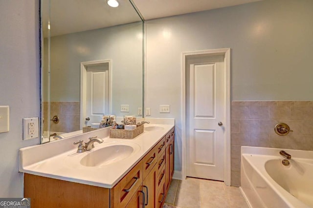 bathroom featuring a garden tub, tile patterned floors, a sink, and double vanity