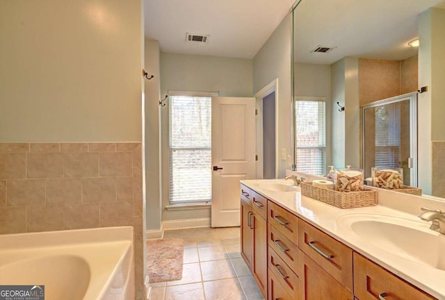 full bath with visible vents, a wealth of natural light, and a sink