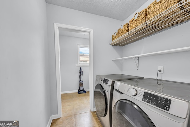 laundry room featuring separate washer and dryer, baseboards, laundry area, and light tile patterned floors