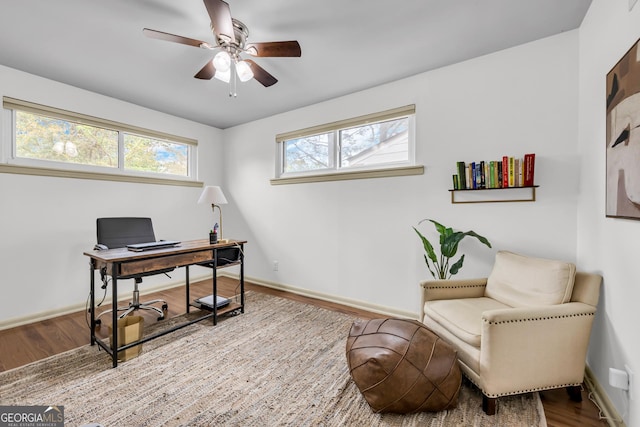 office featuring ceiling fan, baseboards, and wood finished floors