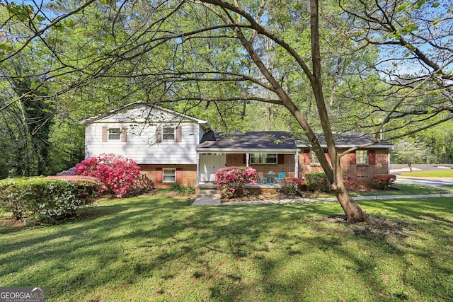 1649 Clairmont Way NE, Brookhaven, GA 30329 - split level home with a porch, a front lawn, and brick siding