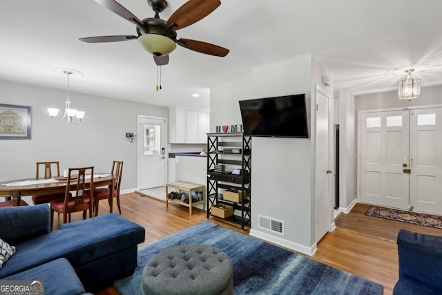 1649 Clairmont Way NE, Brookhaven, GA 30329 - living area with baseboards, wood finished floors, visible vents, and ceiling fan with notable chandelier
