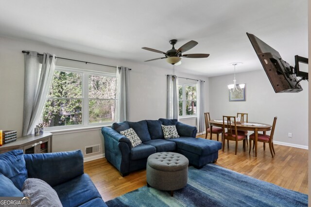 1649 Clairmont Way NE, Brookhaven, GA 30329 - living room with wood finished floors, visible vents, baseboards, and ceiling fan with notable chandelier