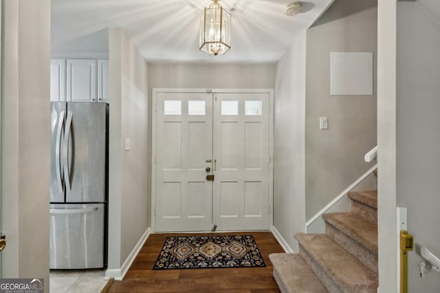 1649 Clairmont Way NE, Brookhaven, GA 30329 - foyer entrance featuring wood finished floors, baseboards, a chandelier, and stairway