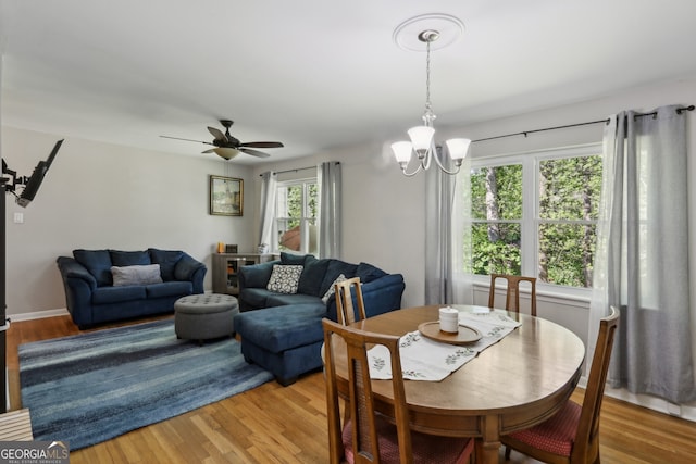 1649 Clairmont Way NE, Brookhaven, GA 30329 - dining space featuring light wood-style floors and ceiling fan with notable chandelier