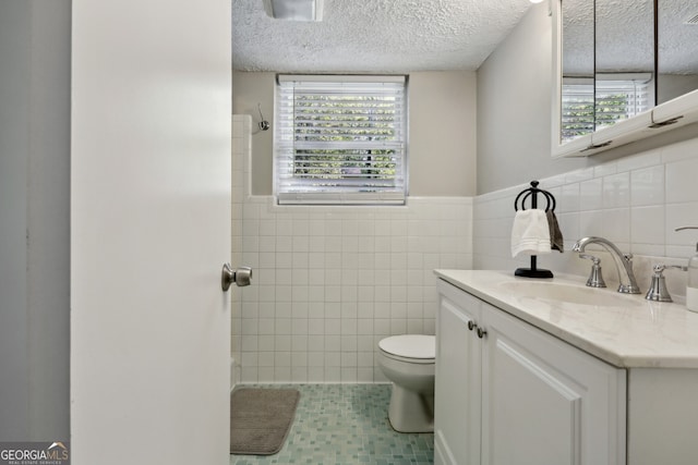 1649 Clairmont Way NE, Brookhaven, GA 30329 - bathroom featuring plenty of natural light, tile patterned floors, toilet, vanity, and tile walls