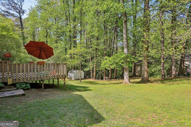 1649 Clairmont Way NE, Brookhaven, GA 30329 - view of yard with a deck, an outbuilding, and a shed