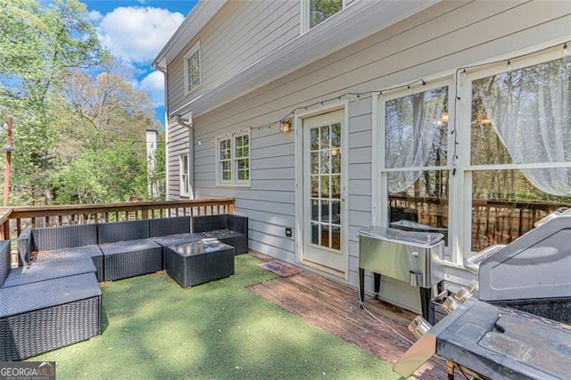 wooden terrace with outdoor lounge area