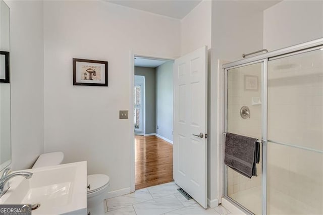 full bathroom featuring a shower stall, marble finish floor, toilet, and vanity