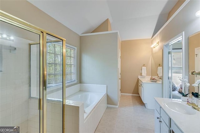 bathroom with two vanities, vaulted ceiling, a sink, and a stall shower