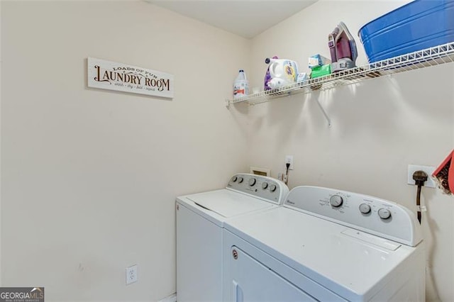 clothes washing area with washing machine and dryer and laundry area