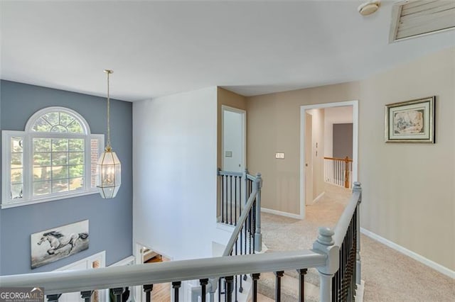 stairs with baseboards and carpet flooring