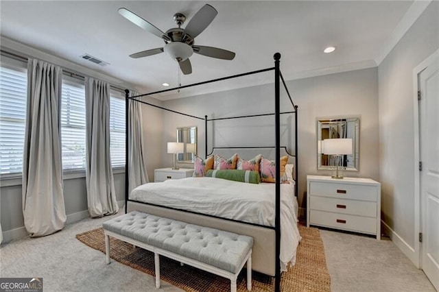 bedroom with multiple windows, visible vents, baseboards, and light carpet