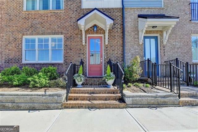 view of exterior entry with brick siding