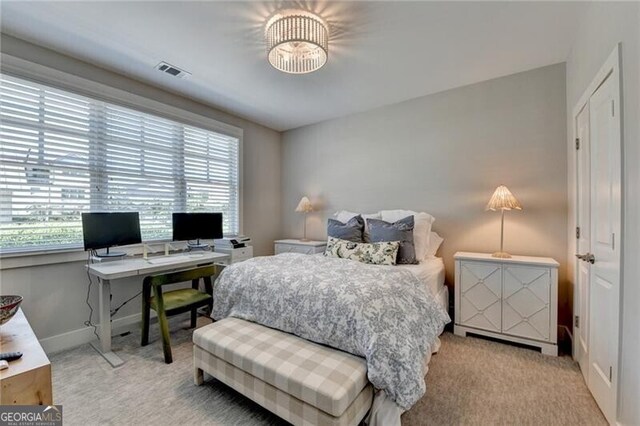 bedroom with carpet, visible vents, and baseboards