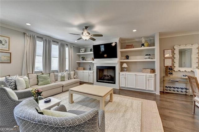 living room featuring ceiling fan, crown molding, dark wood-type flooring, and recessed lighting