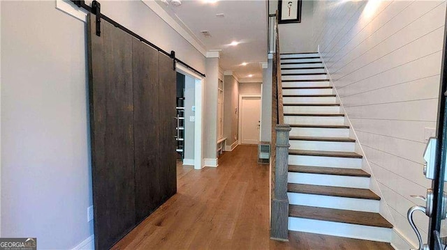 1268 Appleden Way Unit 17, Brookhaven, GA 30319 - staircase featuring a barn door, wood finished floors, and crown molding