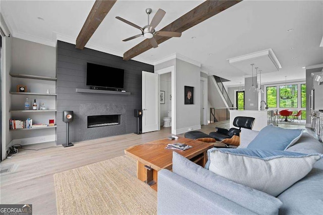 1268 Appleden Way Unit 17, Brookhaven, GA 30319 - living area with ceiling fan, wood finished floors, a fireplace, beam ceiling, and crown molding