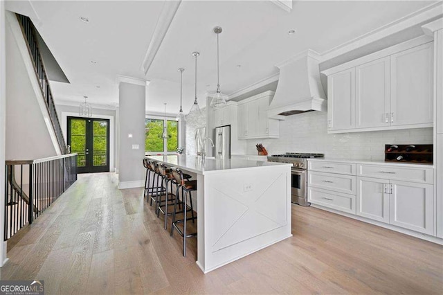 1268 Appleden Way Unit 17, Brookhaven, GA 30319 - kitchen featuring appliances with stainless steel finishes, custom range hood, light wood-style flooring, crown molding, and backsplash