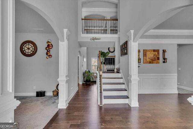 3206 Letha Woods Dr, Conyers, GA 30094 - entryway featuring decorative columns, wood-type flooring, arched walkways, and stairs