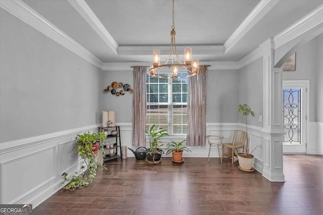 3206 Letha Woods Dr, Conyers, GA 30094 - dining room featuring a chandelier, a raised ceiling, wood finished floors, a wainscoted wall, and a decorative wall