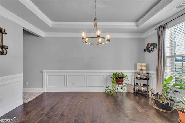 3206 Letha Woods Dr, Conyers, GA 30094 - dining room with a tray ceiling, a chandelier, wood finished floors, wainscoting, and crown molding