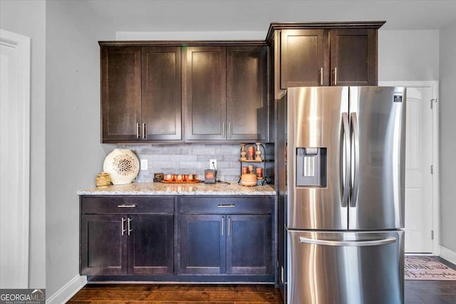 3206 Letha Woods Dr, Conyers, GA 30094 - kitchen with stainless steel fridge, light stone countertops, backsplash, and dark brown cabinets