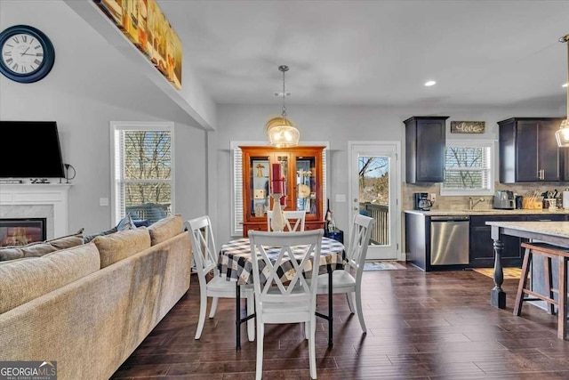 3206 Letha Woods Dr, Conyers, GA 30094 - dining room with a fireplace, recessed lighting, and dark wood-style floors