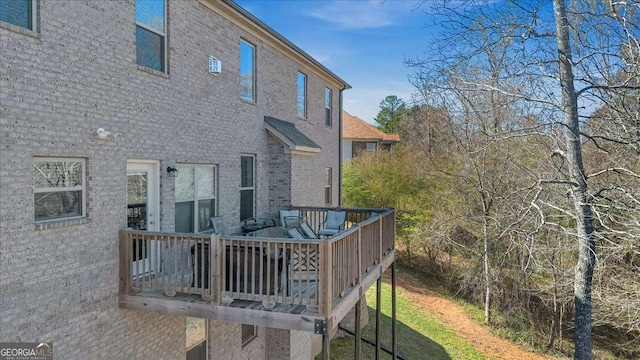 3206 Letha Woods Dr, Conyers, GA 30094 - back of property with brick siding and a deck