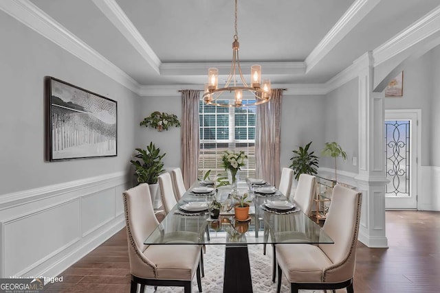 3206 Letha Woods Dr, Conyers, GA 30094 - dining room featuring a chandelier, a raised ceiling, wood finished floors, a wainscoted wall, and a decorative wall