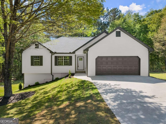 ranch-style house featuring an attached garage, a shingled roof, a front lawn, and driveway