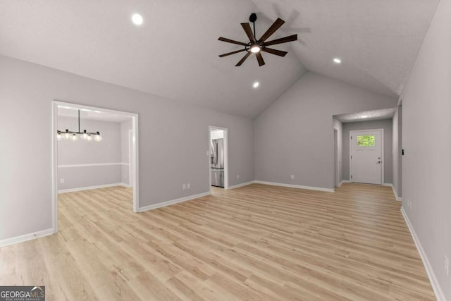 unfurnished living room featuring recessed lighting, lofted ceiling, light wood-style floors, and ceiling fan with notable chandelier
